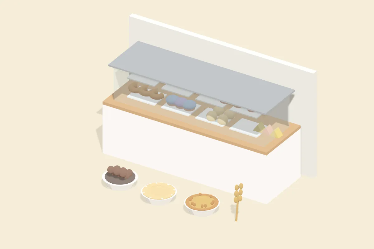 Glasvitrine mit Gebäckstücken, davor Schälchen mit Haselnüssen, Sesam und Weizenkörnern
