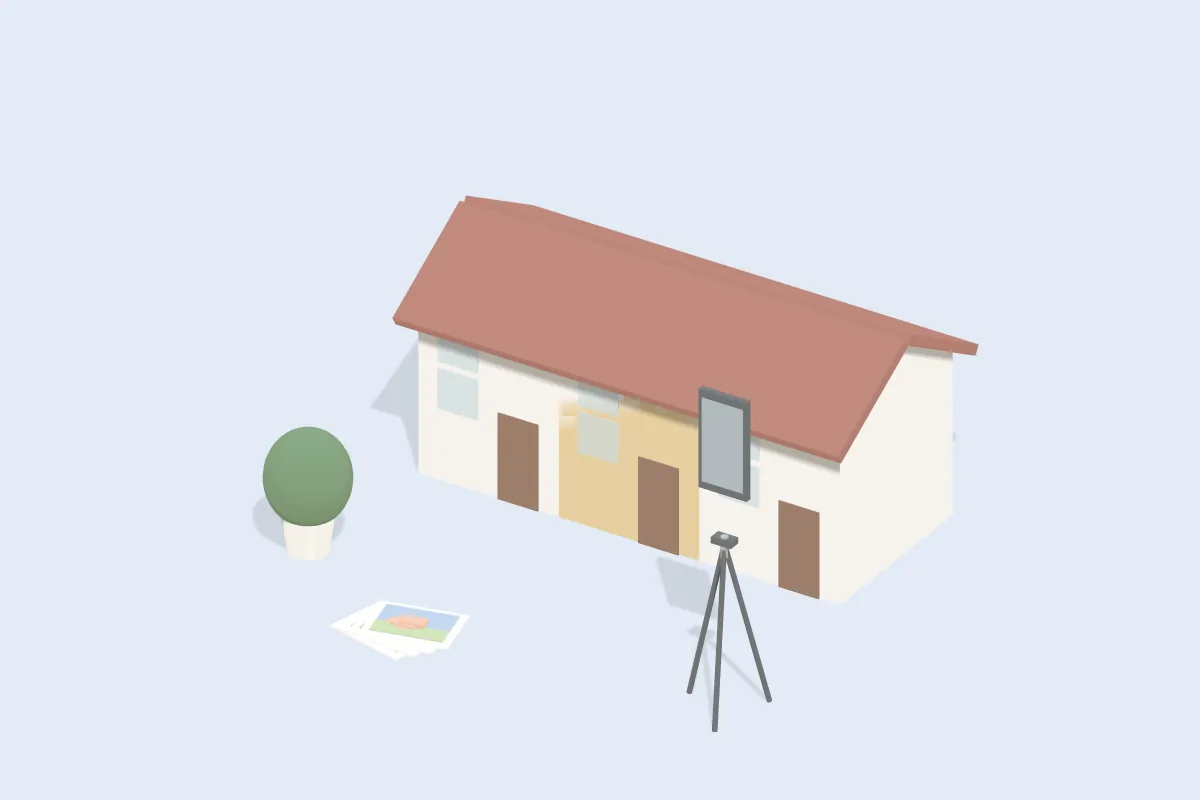 Reihenhaus mit Smartphone auf Stativ davor und ein Stapel Fotos